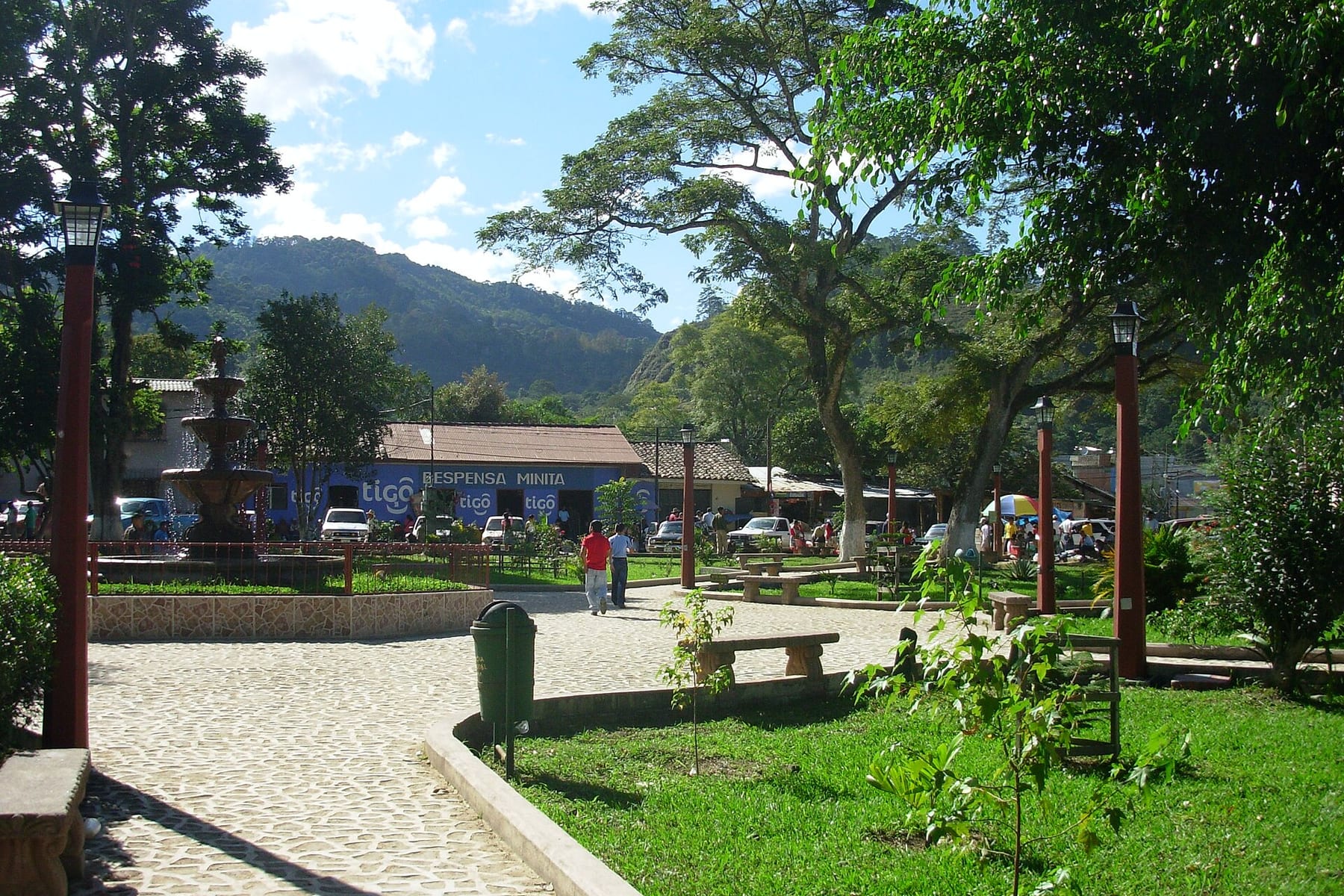 The central park in Marcala with its fountain, benches and lamp posts, hills behind